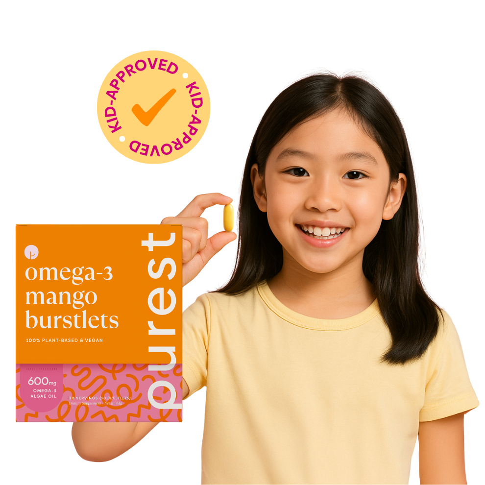 Young female asian kid holding omega-3 mango burstlets